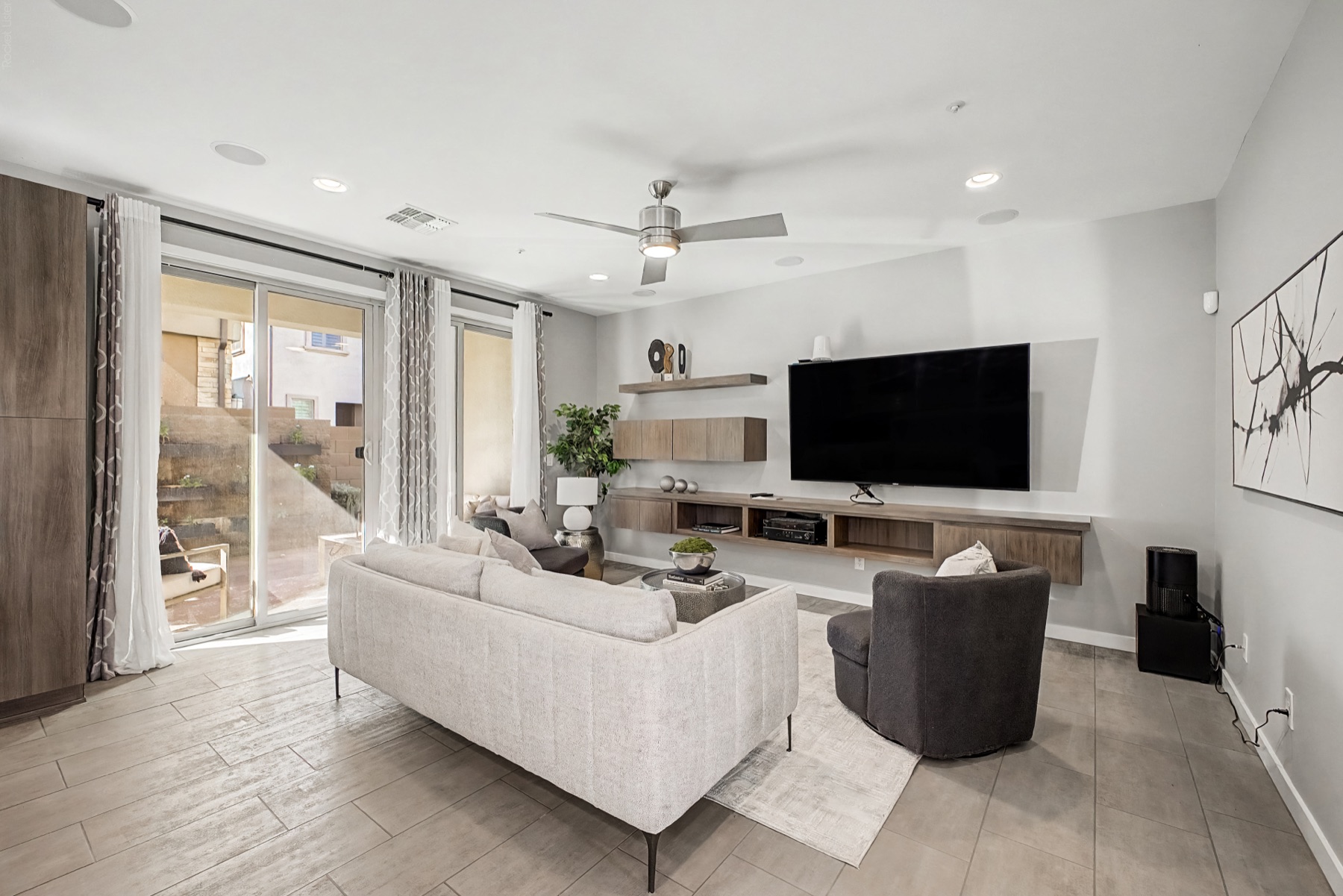 Staged great room with floating cabinetry and integrated media